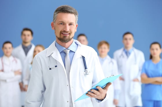bigstock-Male-doctor-with-medical-team-127219841.jpg